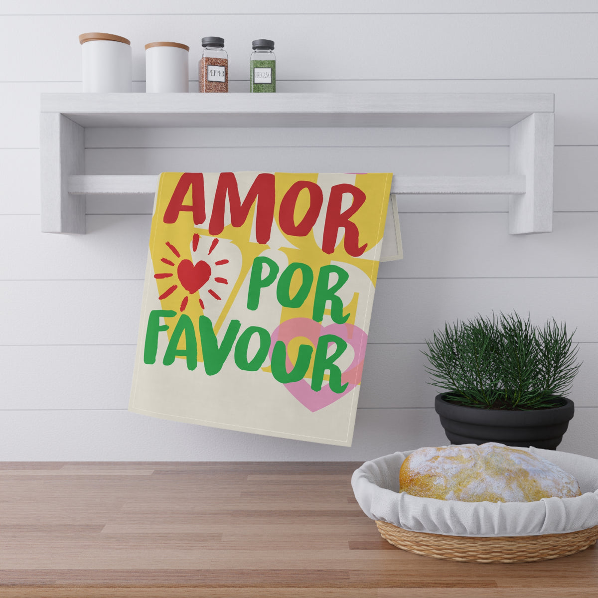 More Amore Por Favour colourful kitchen linen displayed hanging in a kitchen, featuring bold typography and a cheerful retro-inspired design.