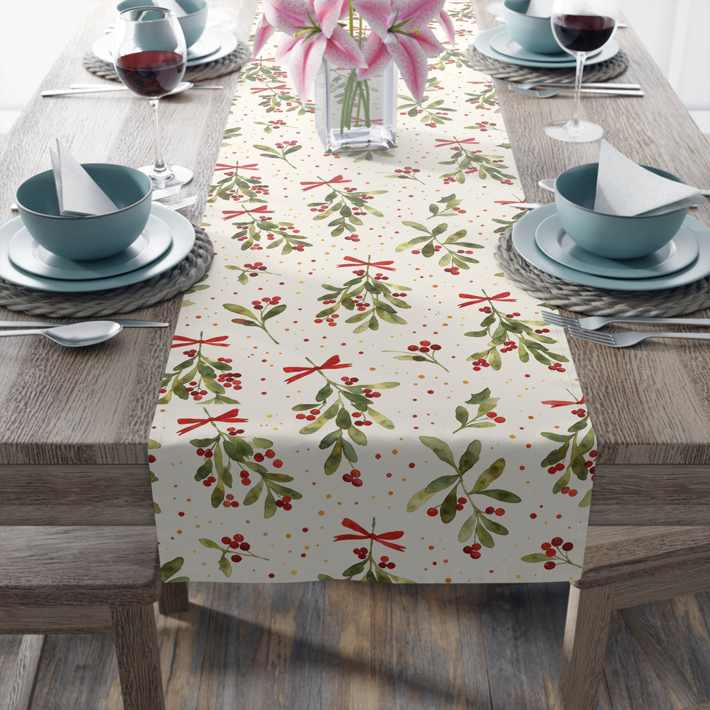 Christmas mistletoe table runner styled with seasonal greenery and candles