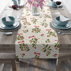 Christmas mistletoe table runner styled with seasonal greenery and candles