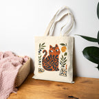 Mediterranean cat tote bag displayed in a home setting with olive branch artwork and coastal-inspired design elements.