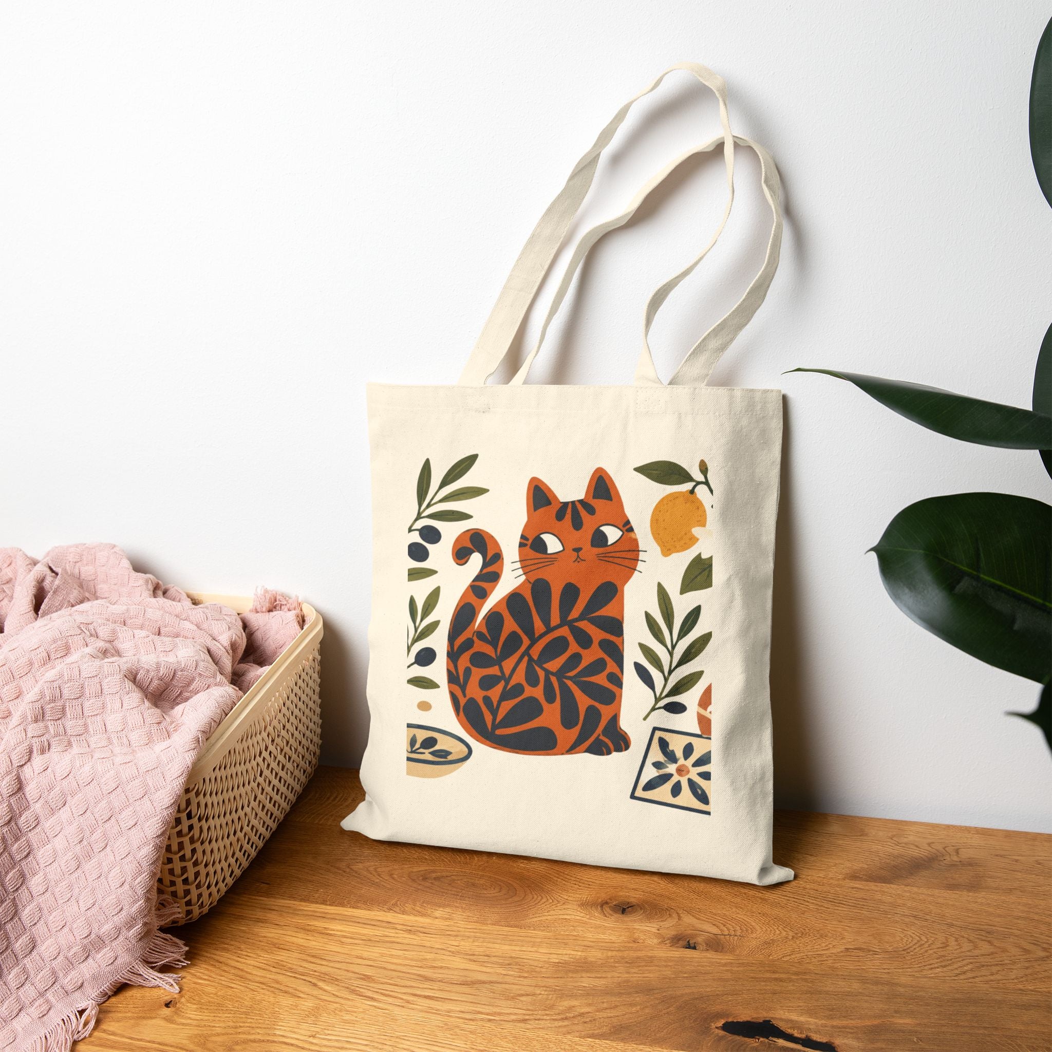 Mediterranean cat tote bag displayed in a home setting with olive branch artwork and coastal-inspired design elements.