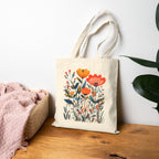 Stylish reusable market tote with vibrant botanical bouquet available in natural and black canvas.