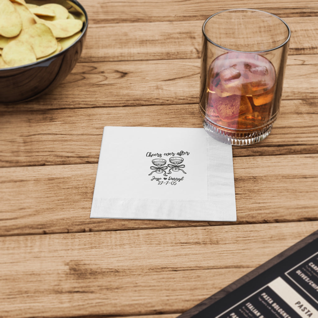 Custom wedding reception napkin with elegant cocktail glasses, personalized with the couple's names and special date.