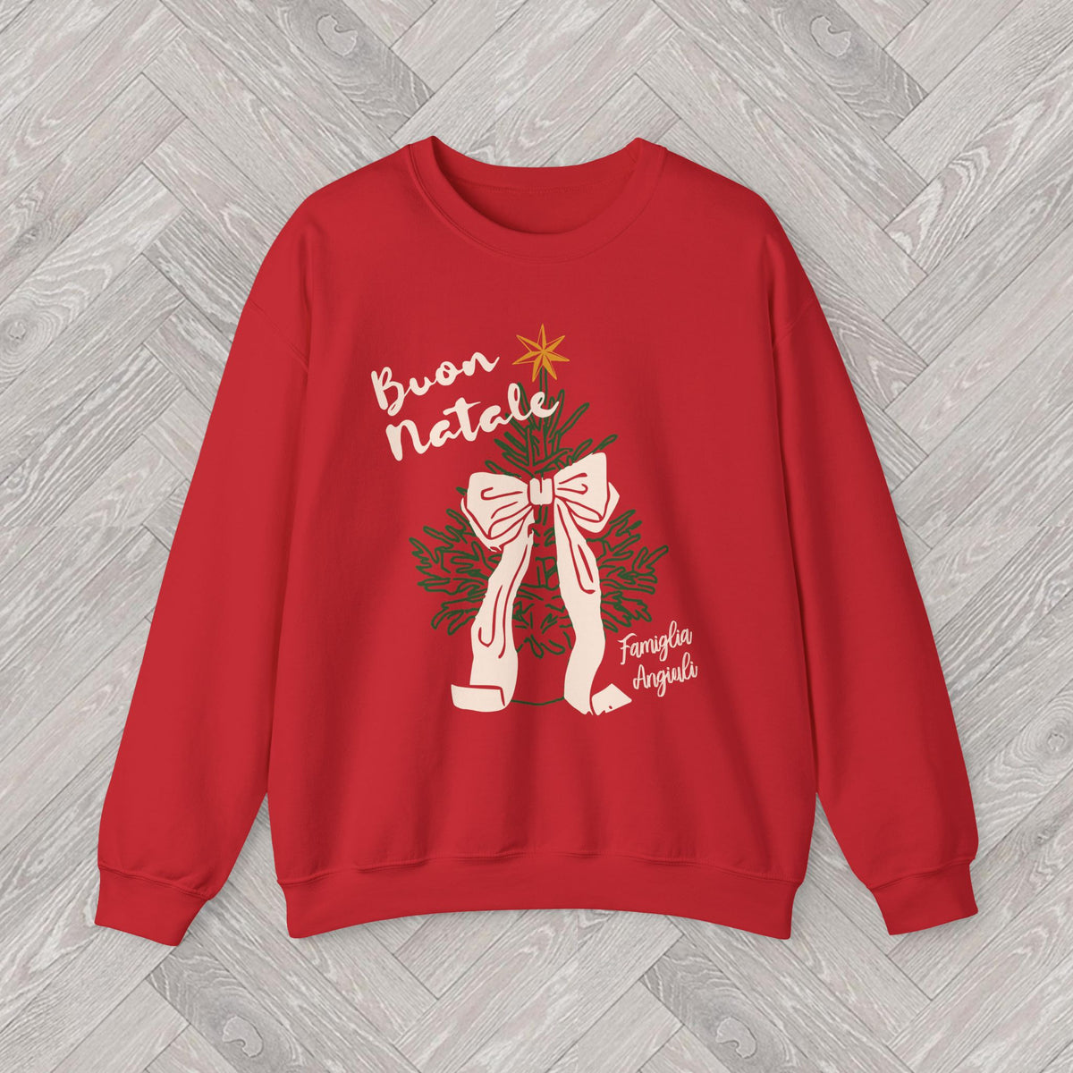 Close-up of the Buon Natale Christmas sweatshirt design with festive Italian lettering, green Christmas tree branches and a ribbon bow.