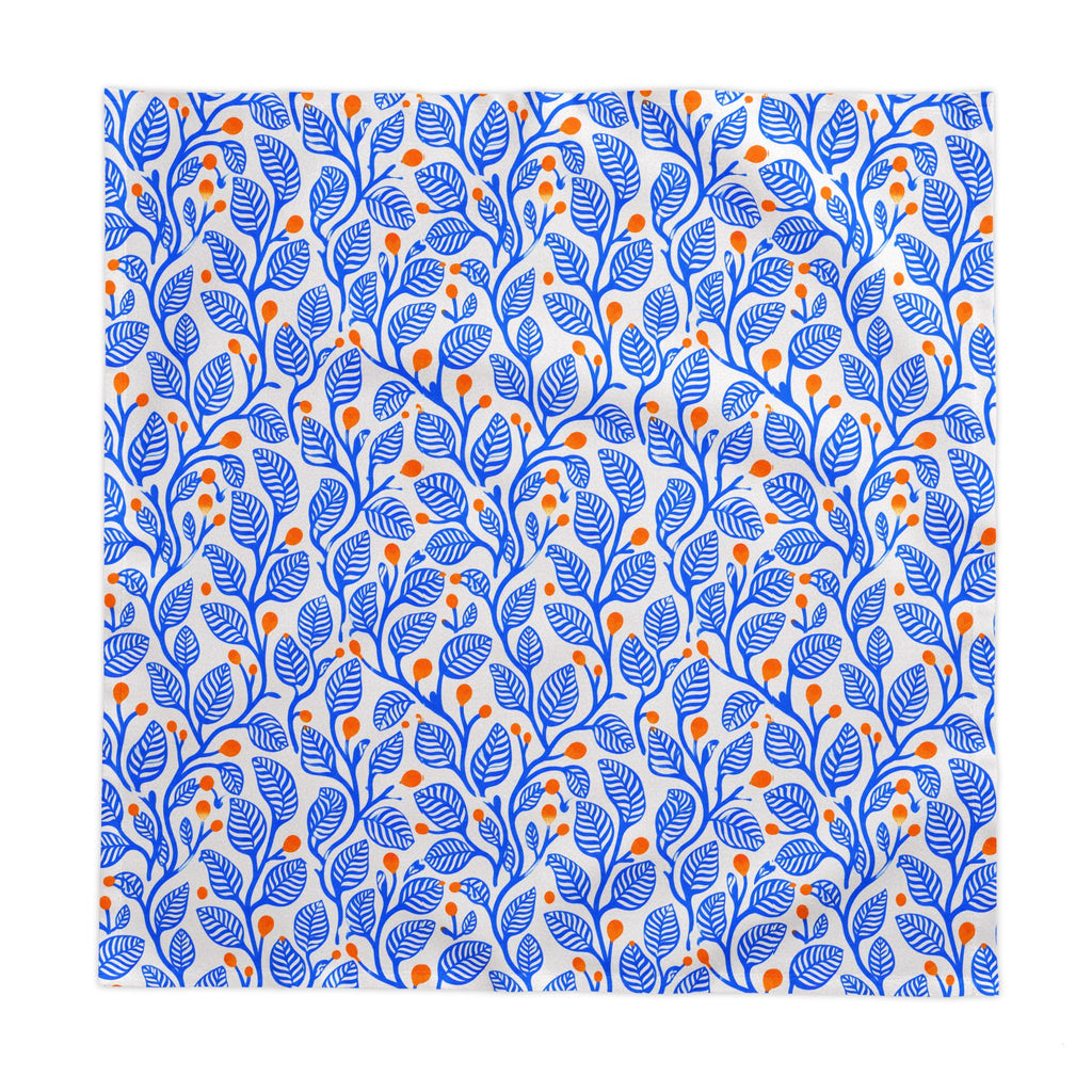 Mediterranean botanical dining table linen with a bold blue leaf pattern and terracotta accents for stylish everyday entertaining.