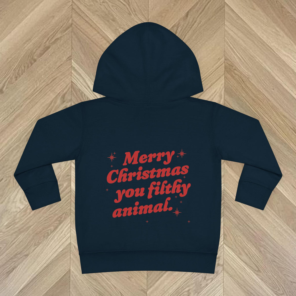Close-up of Navy Christmas lettering and festive stars on the back of the Merry Christmas You Filthy Animal kids hoodie.