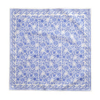 Blue and white fruit-patterned tablecloth styled for an elegant dining table