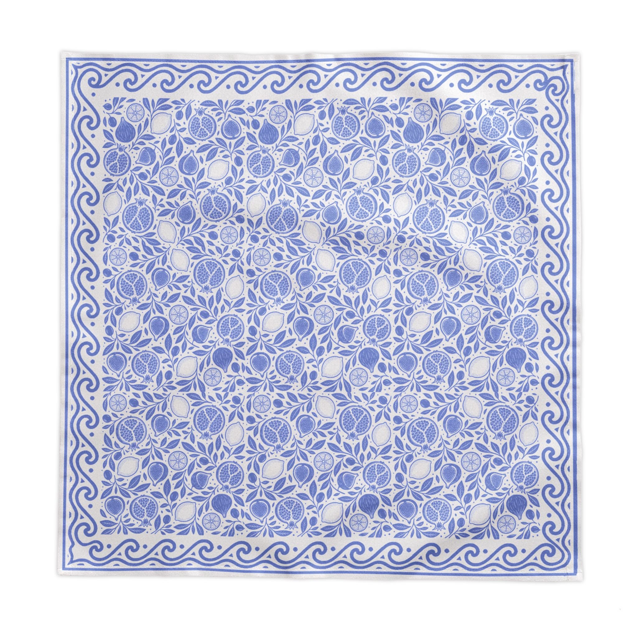 Blue and white fruit-patterned tablecloth styled for an elegant dining table