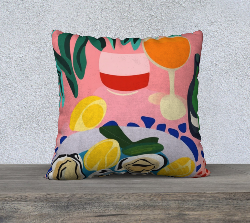 Decorative Oysters & Wine cushion with bright, Mediterranean vibes on an armchair in a chic home decor setup.