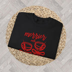 Close up Black crewneck sweatshirt featuring the “Merrier with a Martini” holiday cocktail design, cute Christmas gift.