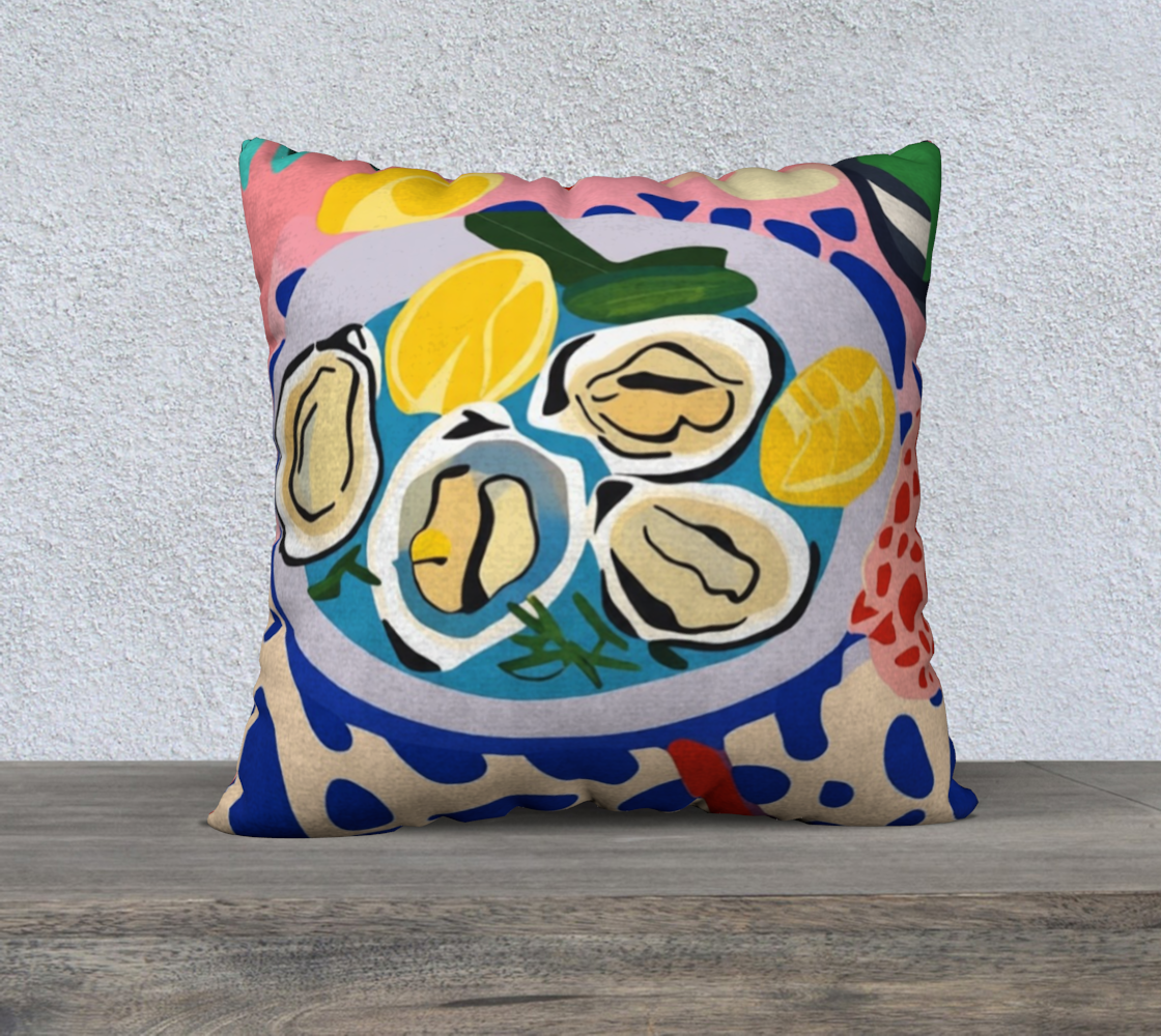 Lifestyle image featuring Oysters & Wine cushion placed on a sofa with a cozy, Mediterranean-inspired setting.