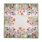 Colourful floral cotton twill tablecloth draped over dining table showing vibrant meadow-inspired pattern