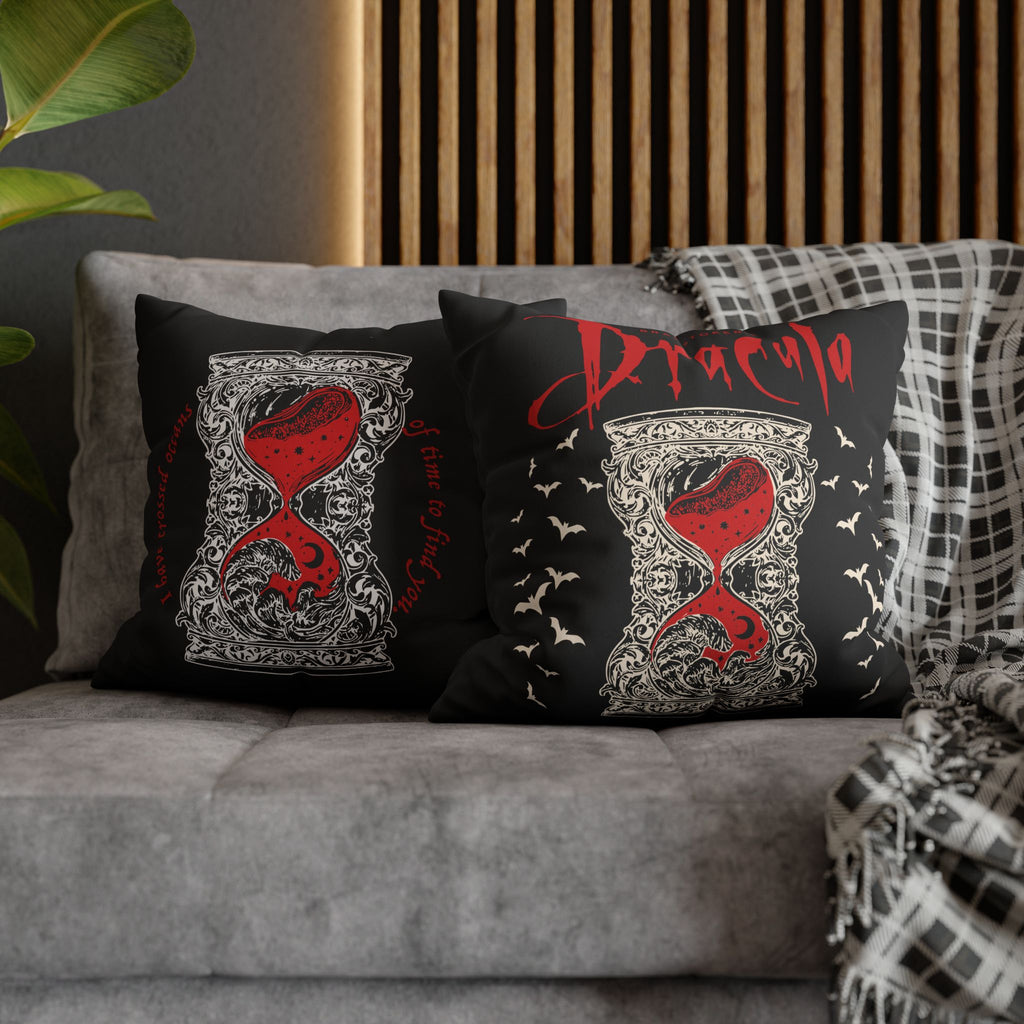 Close-up of ornate ivory detailing and red hourglass artwork on a Dracula gothic pillow cover.