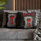Close-up of ornate ivory detailing and red hourglass artwork on a Dracula gothic pillow cover.