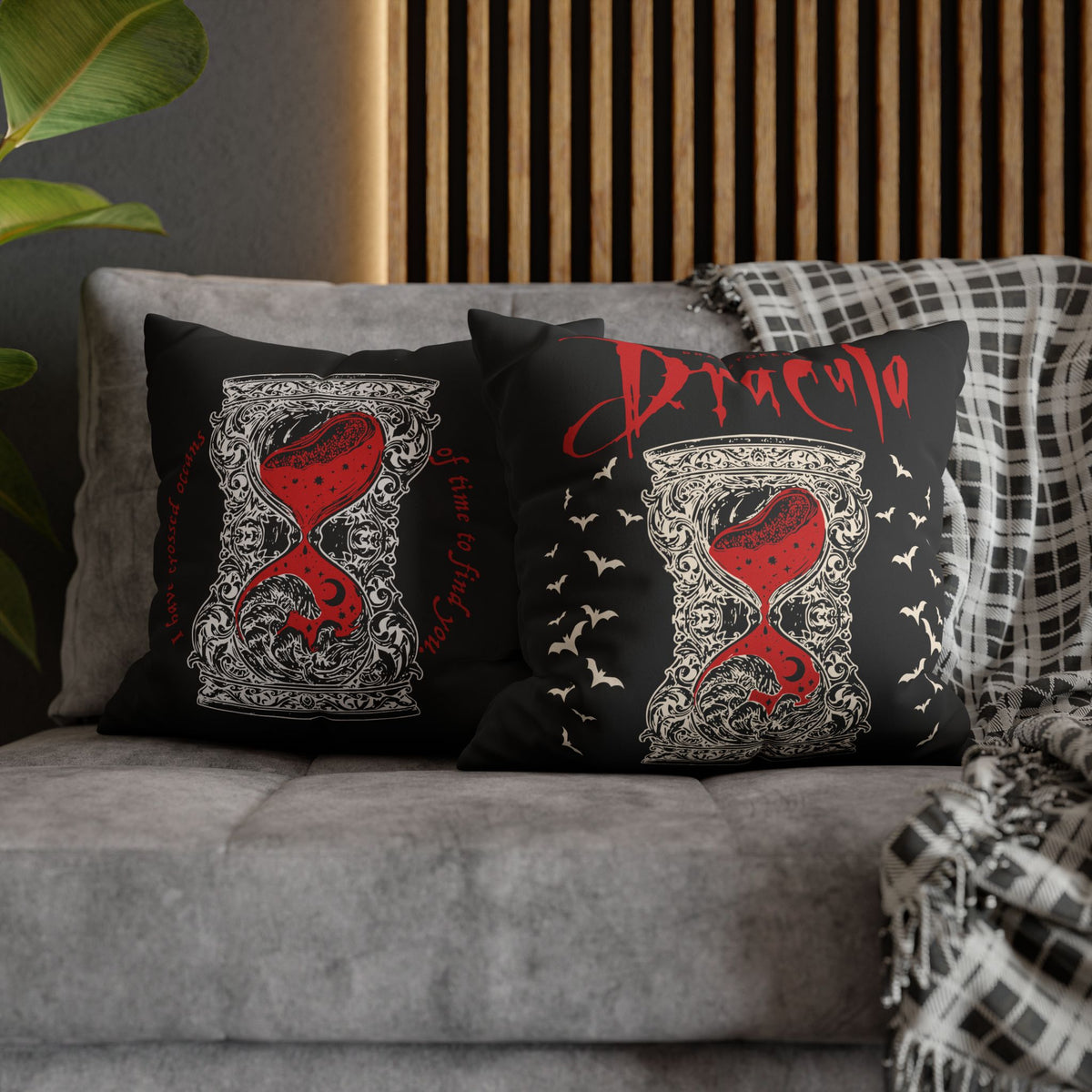 Close-up of ornate ivory detailing and red hourglass artwork on a Dracula gothic pillow cover.