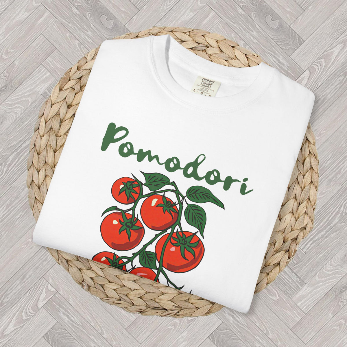 Close-up of colorful Pomodori tomato vine artwork and Italian-inspired typography printed on a soft garment-dyed Comfort Colors shirt