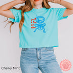 Chalky mint green crop top with playful 'Just A Tini Bit Older' print and martini design for birthday girls.