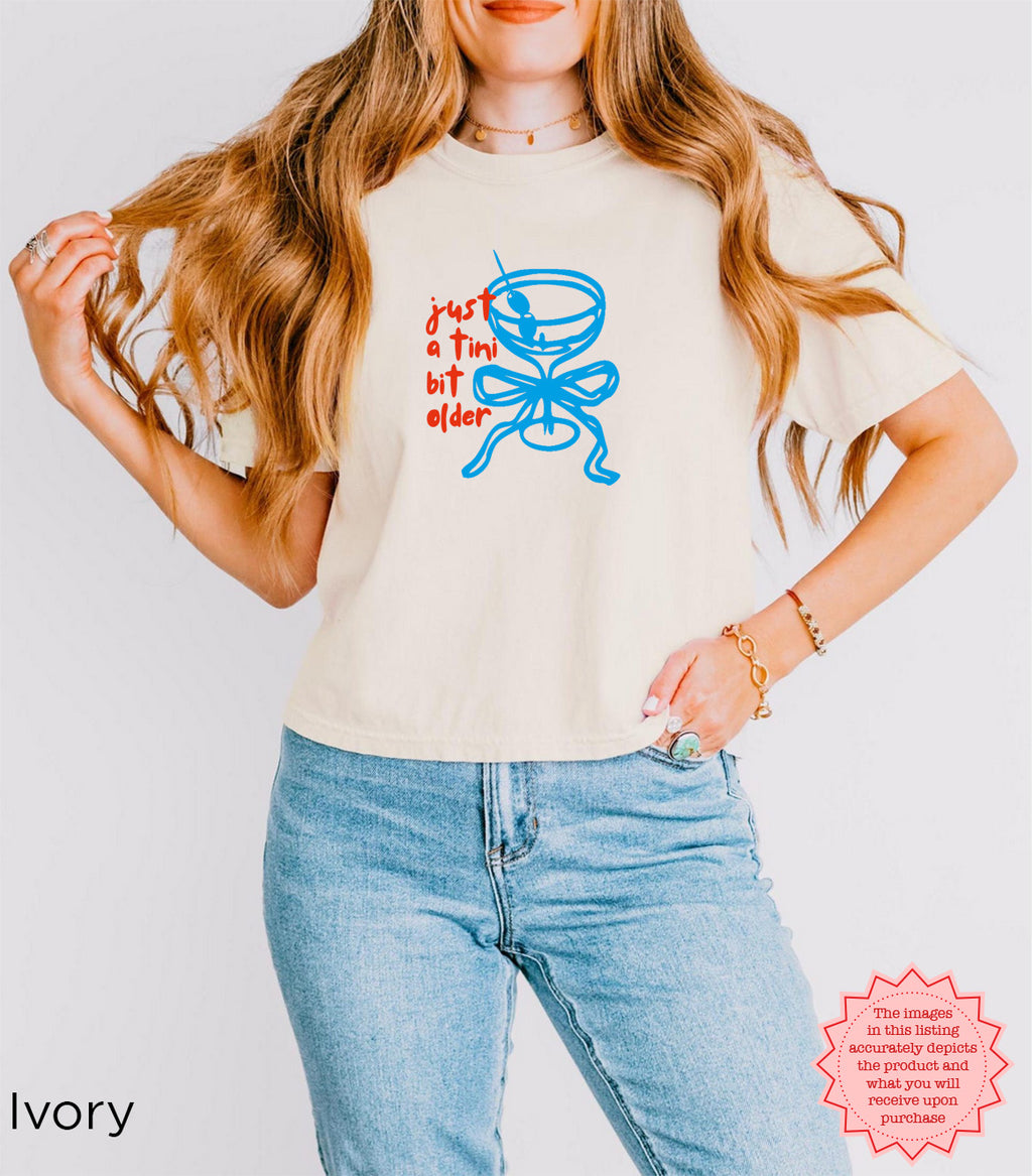 Ivory crop top with 'Just A Tini Bit Older' design, ideal for 30th birthday celebrations and party vibes.