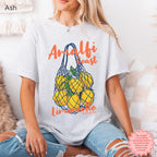 Amalfi Coast Lemoncello white graphic tee styled for a sunny coastal vacation-inspired look