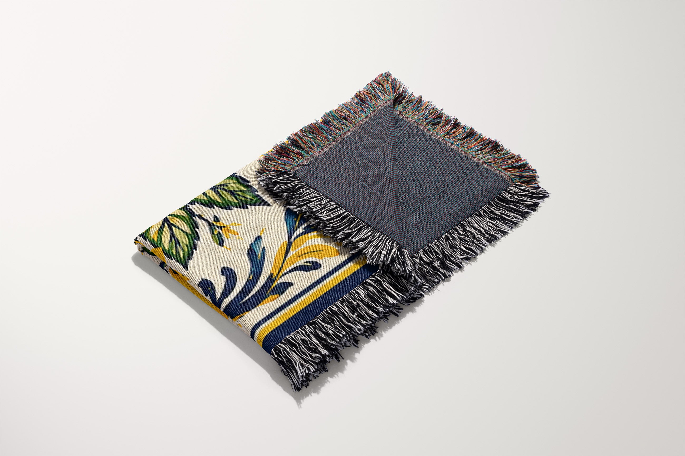 Close-up view of woven cotton texture and colorful fringed edges on a Mediterranean lemon blanket
