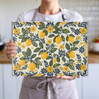 Mediterranean-inspired glass cutting board with decorative yellow lemons and botanical foliage