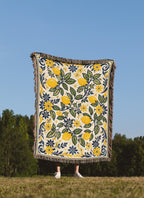 Mediterranean citrus woven blanket with golden lemons, navy accents, and elegant floral border artwork