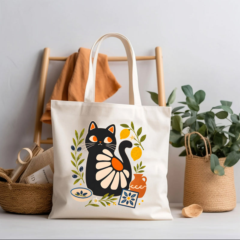Mediterranean Black Matisse Cat Tote Bag featuring olive branches, lemons, terracotta pottery, and coastal tile motifs printed on natural cotton canvas.