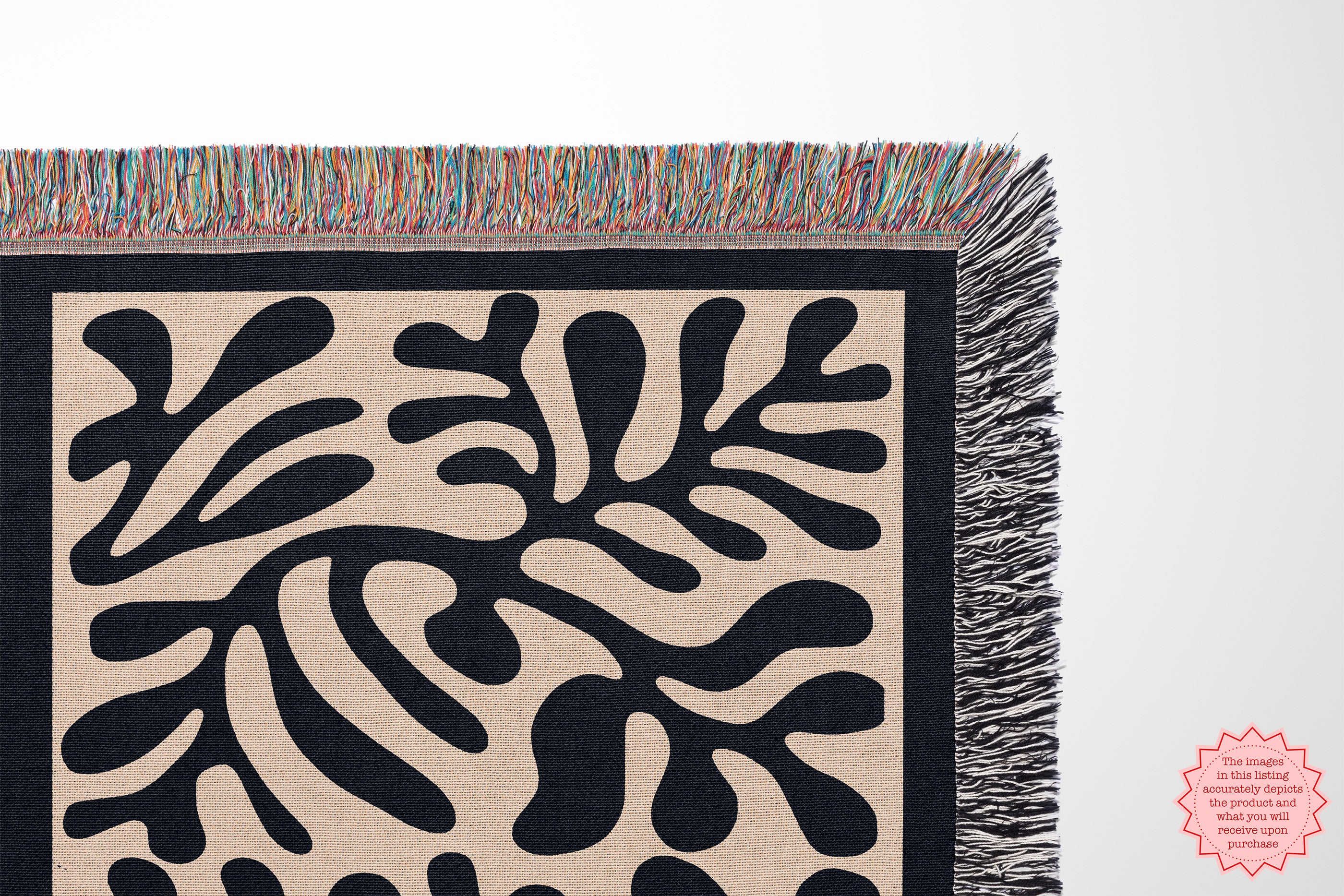 Person holding the Black Matisse Pattern Woven Blanket outdoors, showing its minimalist design and artistic details.