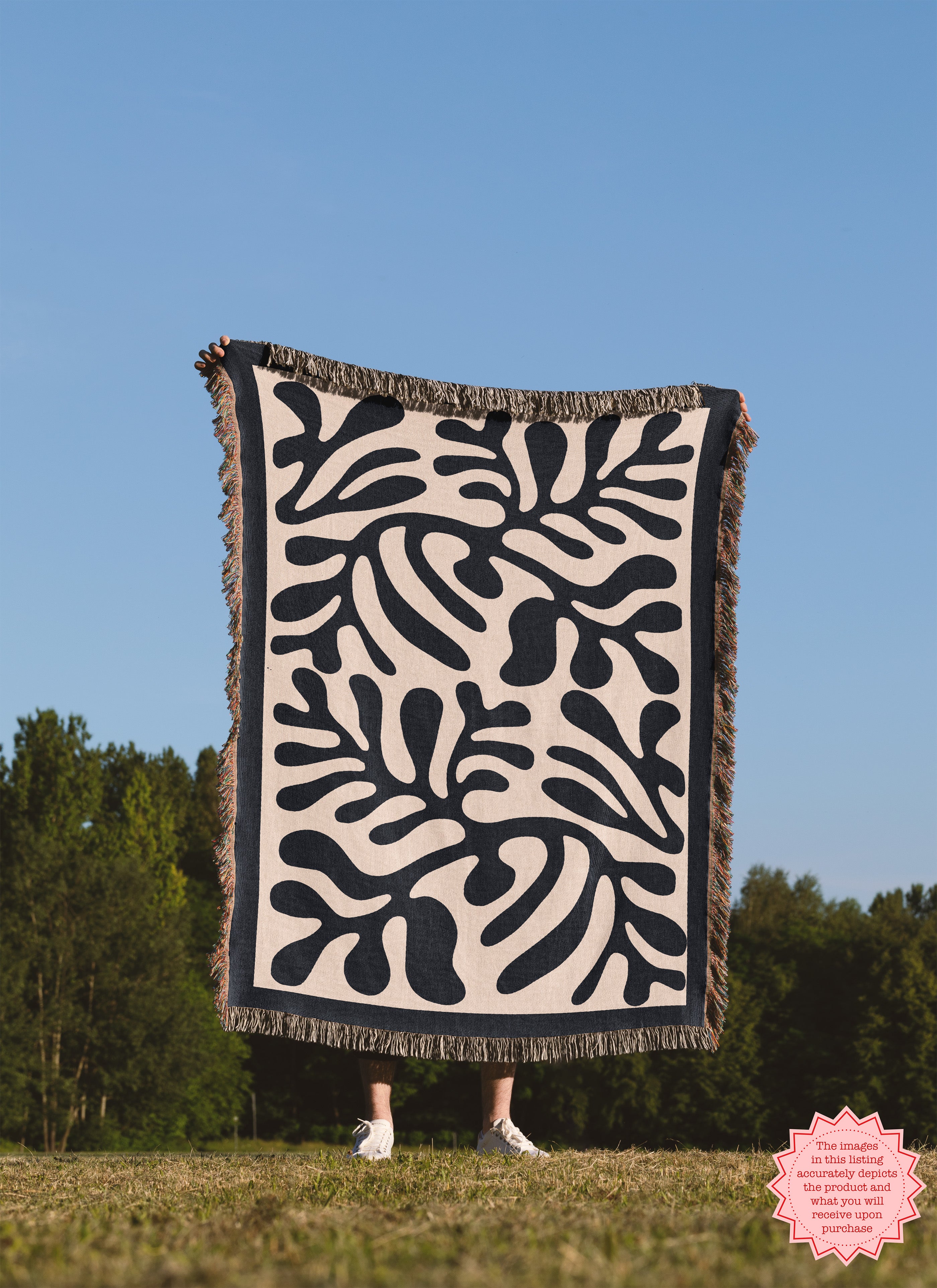 Close-up of the Black Matisse Pattern Woven Blanket, featuring bold abstract shapes and vibrant fringed edges.