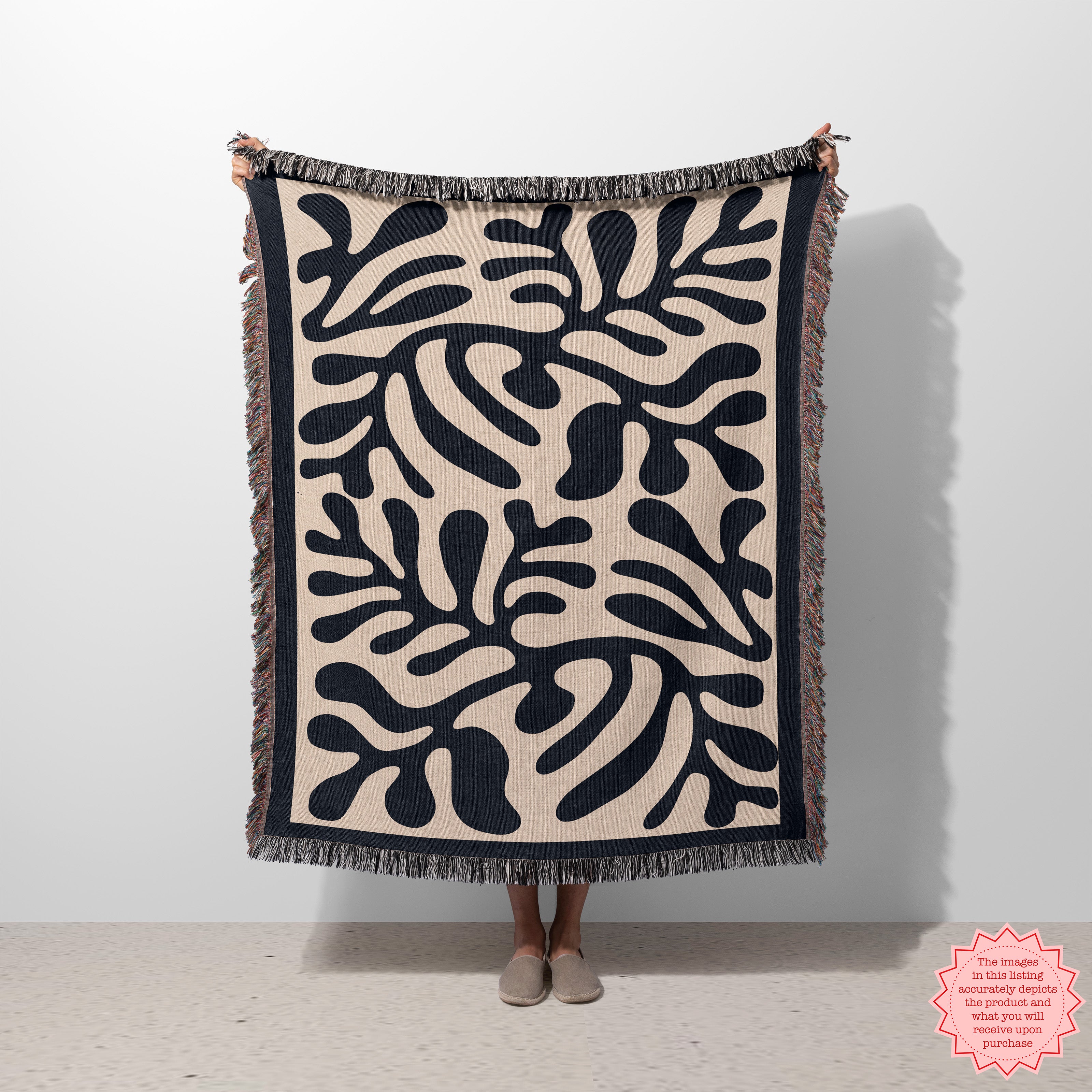 Black Matisse Pattern Woven Blanket with colorful fringed edges, showcasing an abstract, modern art design in black and beige.