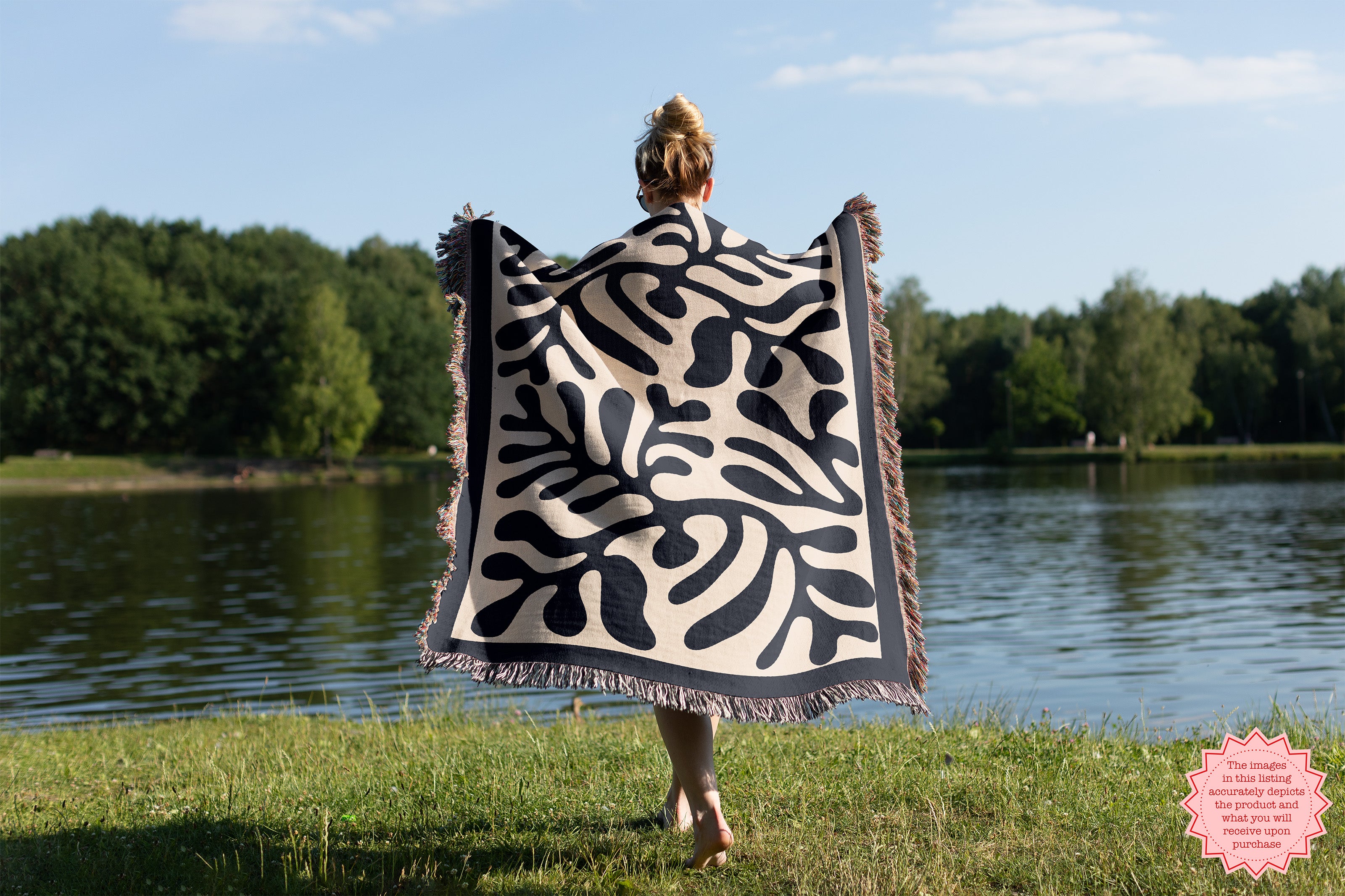 Artistic Black Matisse Pattern Woven Throw draped on a sofa, adding a modern and cozy touch to a contemporary living room.