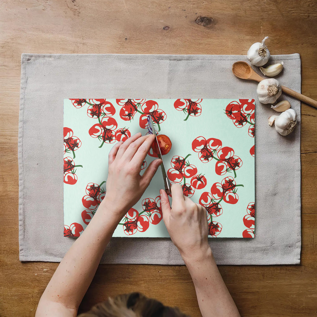 Tomato print glass cutting board displayed on a kitchen countertop