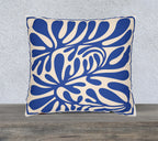 Blue Mediterranean abstract faux suede cushion featuring oversized botanical cut-paper inspired artwork on a square decorative throw pillow.