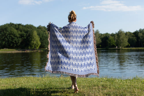 100% cotton coastal throw blanket with woven fish design inspired by nautical and Mediterranean home decor