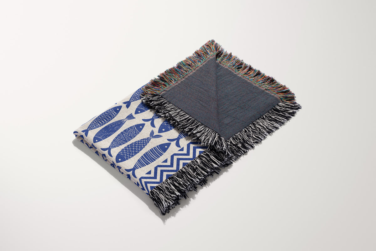 Decorative fish tapestry blanket made from cotton with fringed edges and a modern coastal design