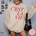 Sand color C’EST LA VIE sweatshirt, casual Paris-inspired streetwear, cozy oversized crewneck look