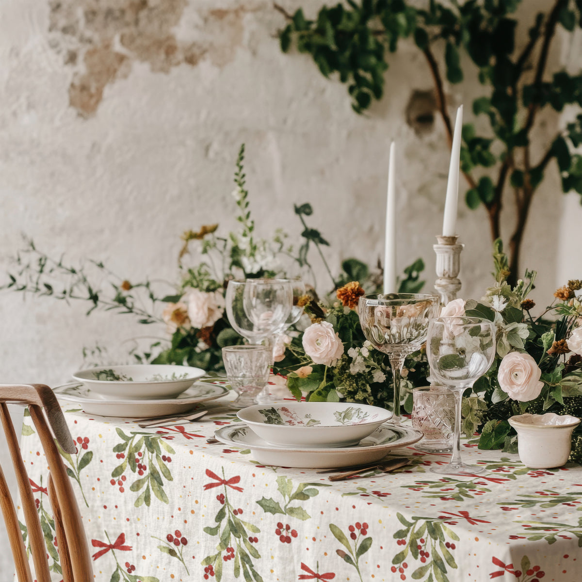 Full view of the watercolour Christmas mistletoe tablecloth displaying its botanical pattern across the dining table.