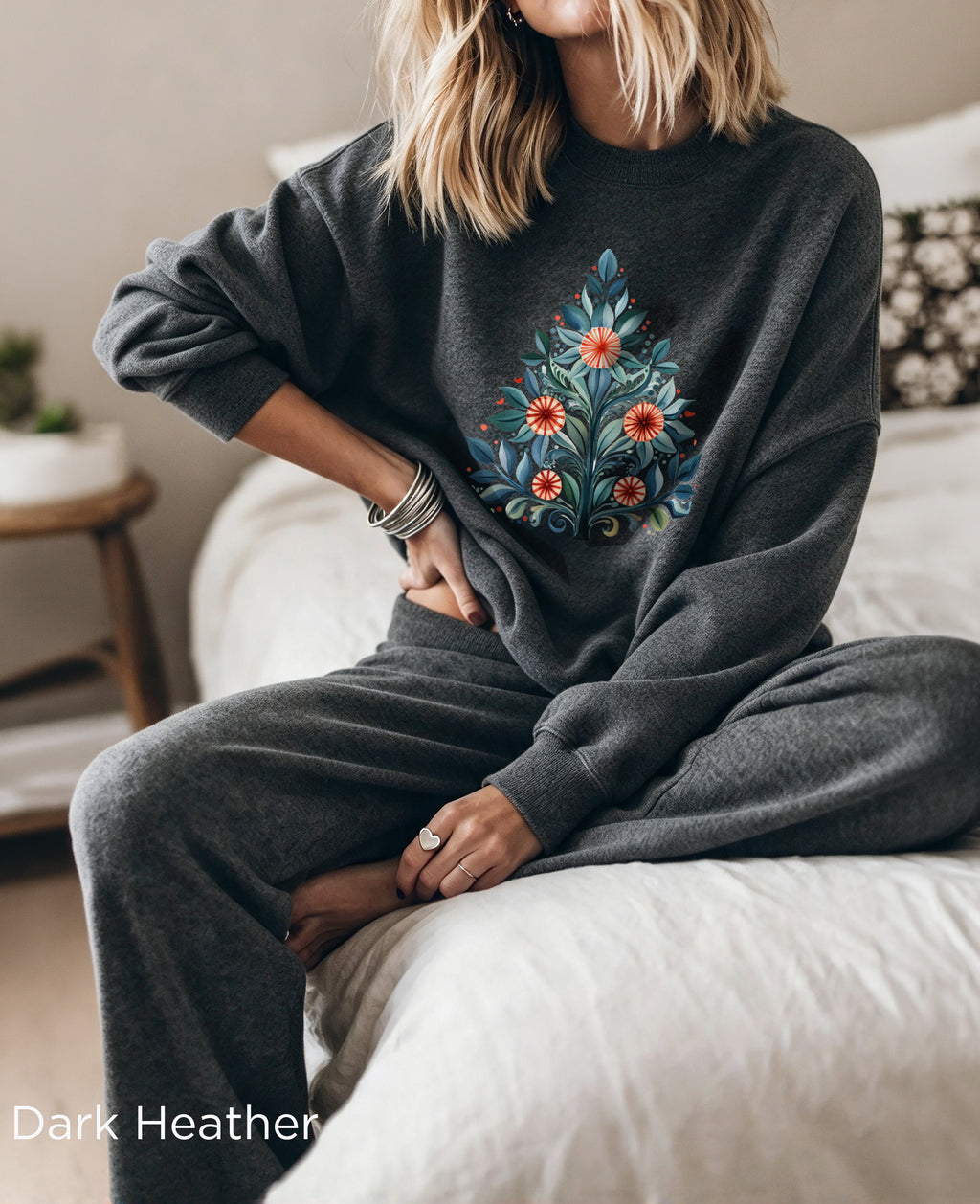 Dark Heather Christmas sweatshirt with Mediterranean-inspired folk-art Christmas tree design, featuring blue and green leaves with red and orange decorative flowers.
