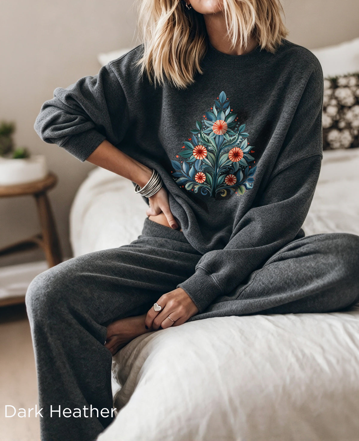 Dark Heather Christmas sweatshirt with Mediterranean-inspired folk-art Christmas tree design, featuring blue and green leaves with red and orange decorative flowers.