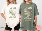 Green and Cream Cin Cin the Bride shirt styled casual – relaxed fit bachelorette party tee paired with a pink gingham skirt, perfect for wedding weekend fun.