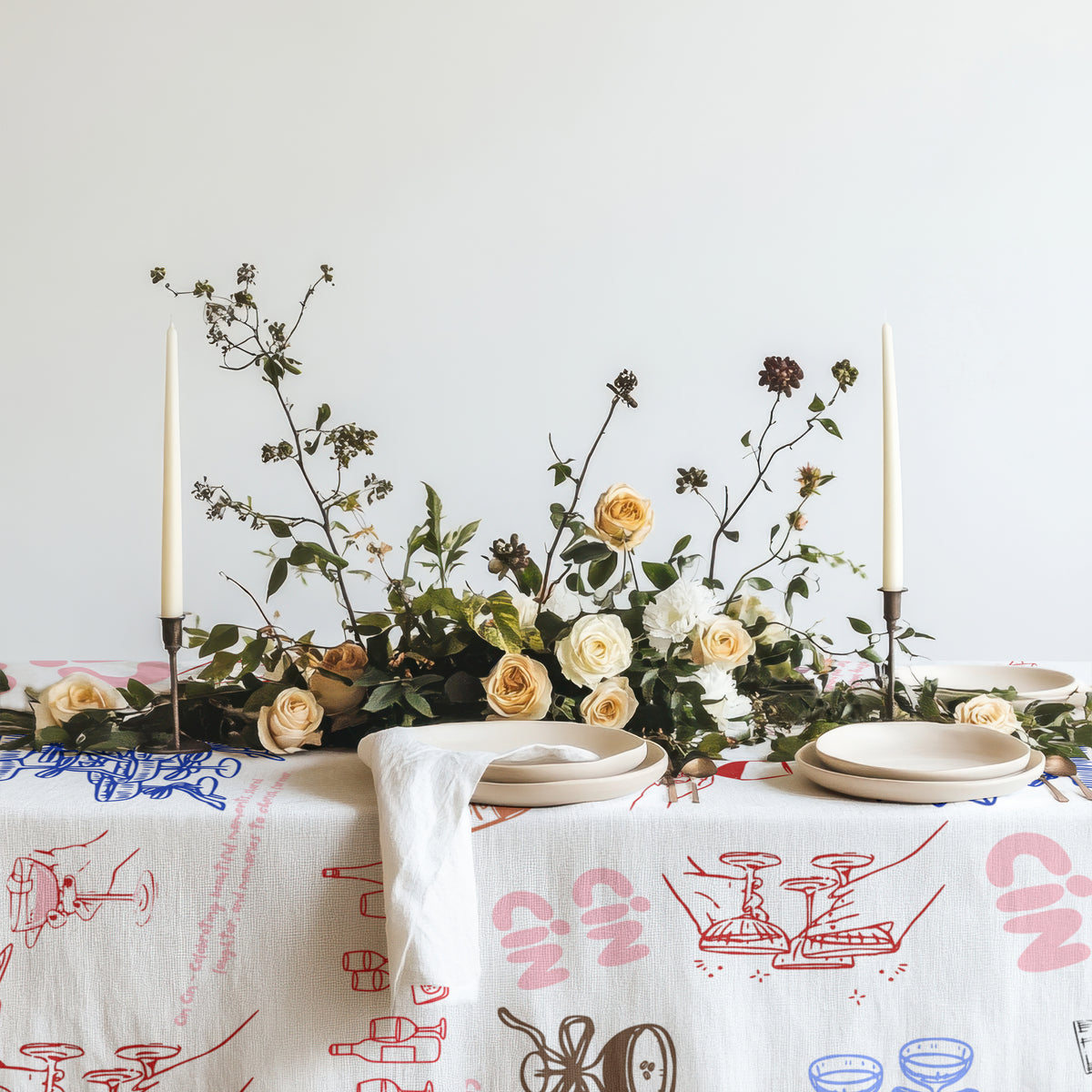 Italian inspired cotton twill tablecloth with whimsical hand-drawn wine glasses, champagne, cocktails, and celebration motifs