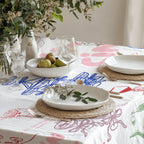 Close-up view of hand-drawn cocktail, wine bottle, glassware and ribbon illustrations on Italian celebration table linen