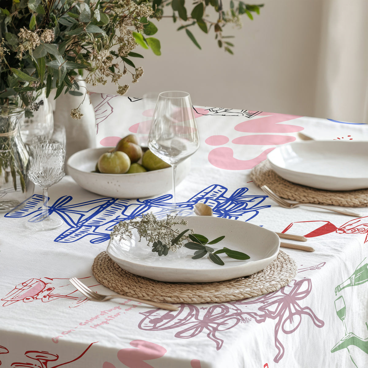 Close-up view of hand-drawn cocktail, wine bottle, glassware and ribbon illustrations on Italian celebration table linen