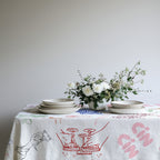 Cin Cin Celebration Tablecloth draped over dining table showcasing whimsical Italian celebration pattern for modern home decor