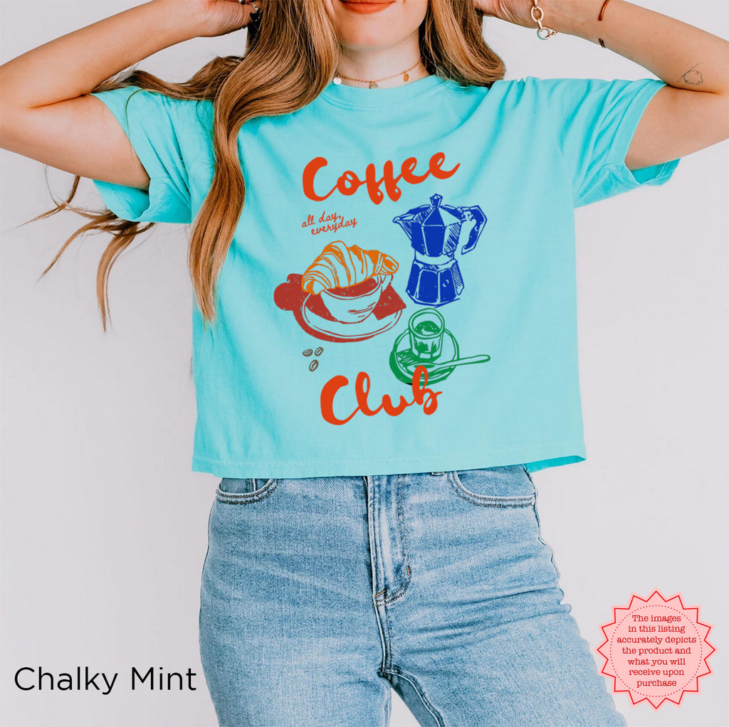 Trendy chalky mint crop top with a retro coffee design, featuring a coffee cup, moka pot, and croissant in vibrant colors.