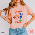 Peach coffee club cropped tee with retro illustrations of coffee and croissant, bringing style to your coffee-loving wardrobe.