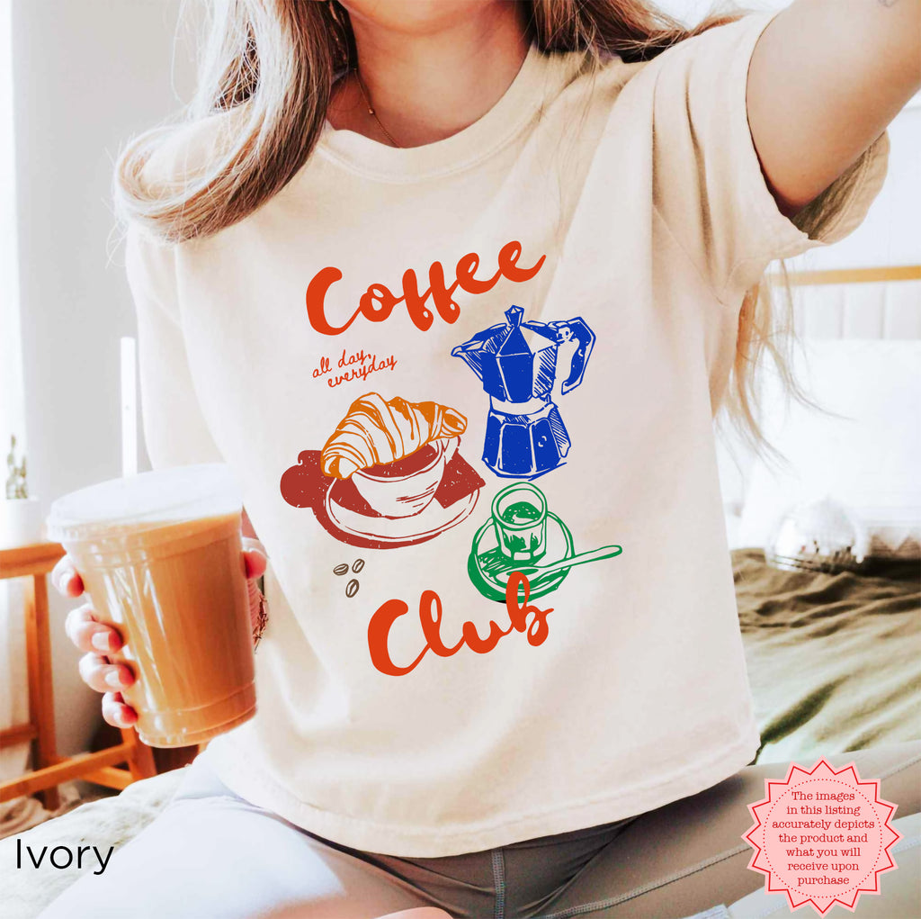 Ivory Coffee Club crop top with a playful design of coffee-related illustrations, ideal for coffee enthusiasts.