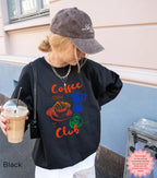 Black Coffee Club sweatshirt with a bold, retro coffee graphic of a croissant, espresso machine, and coffee cup. Comfortable and stylish for casual wear.