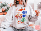 White Coffee Club sweatshirt with a colorful coffee-themed graphic design, featuring a croissant, espresso machine, and coffee cup. Perfect for casual coffee lovers.