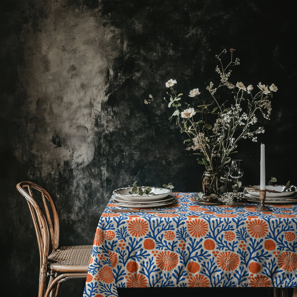 Blue and terracotta coral reef tablecloth creating a vibrant Mediterranean-inspired dining table.
